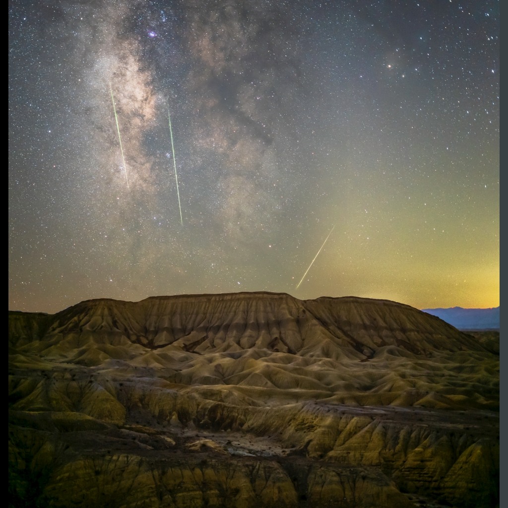 a landscape of a desert with a starry sky